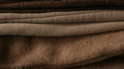 A close-up stack of folded bedding fabric