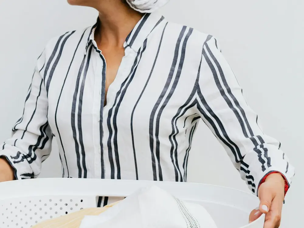 Cleaning crew partner preparing laundry after checkout