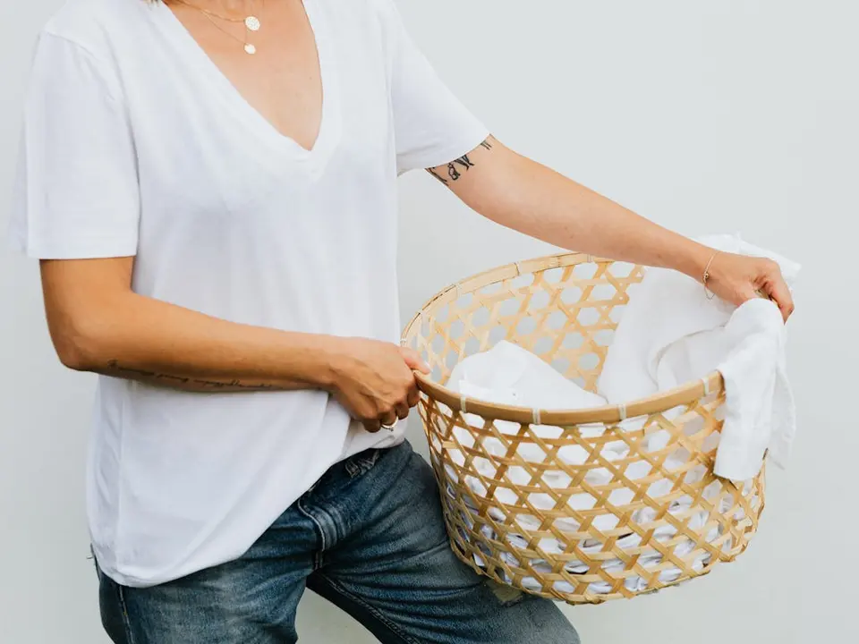 Laundry basket ready beside a phone before booking