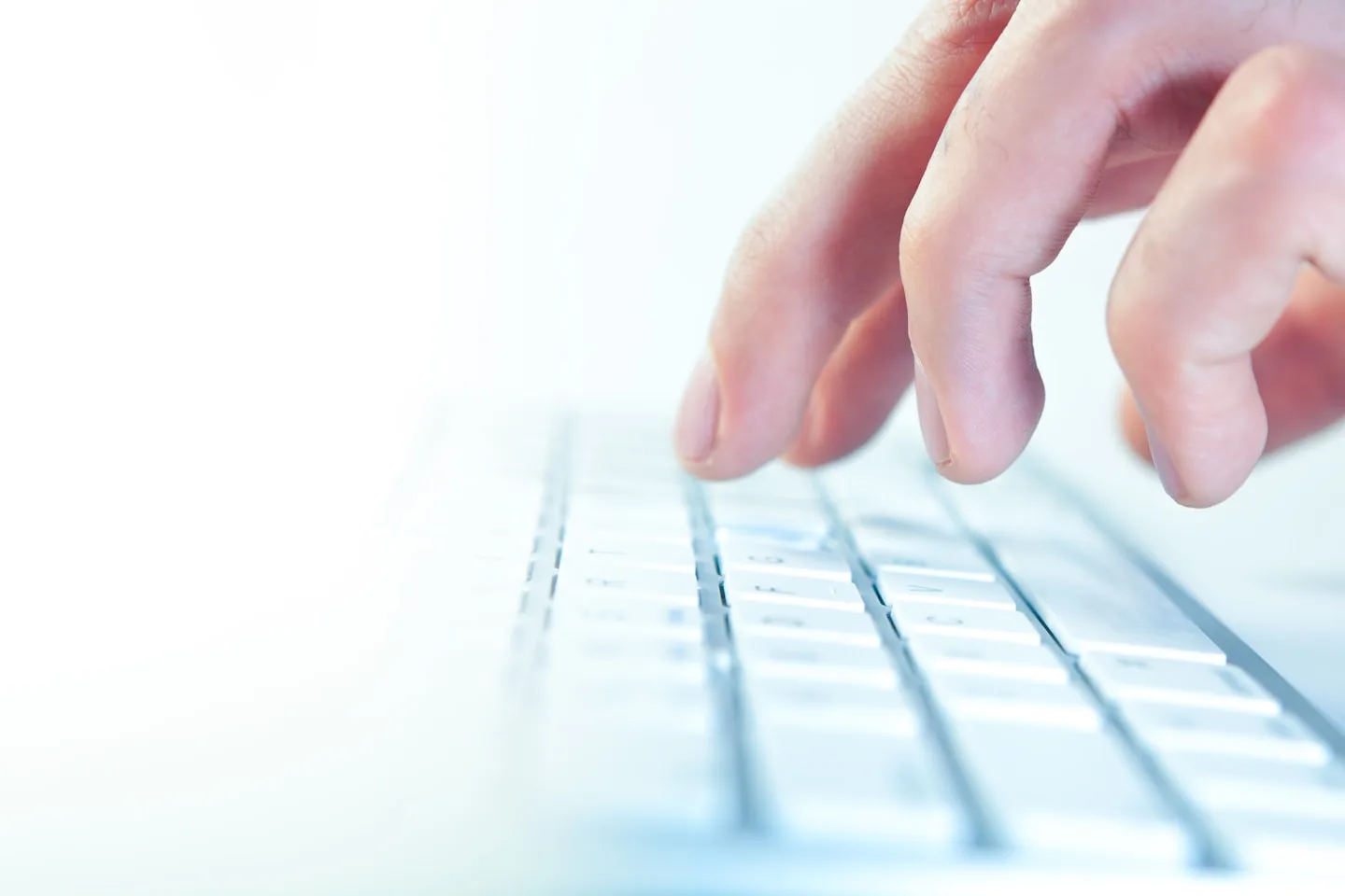 Hands using a keyboard while reviewing an accessible service page