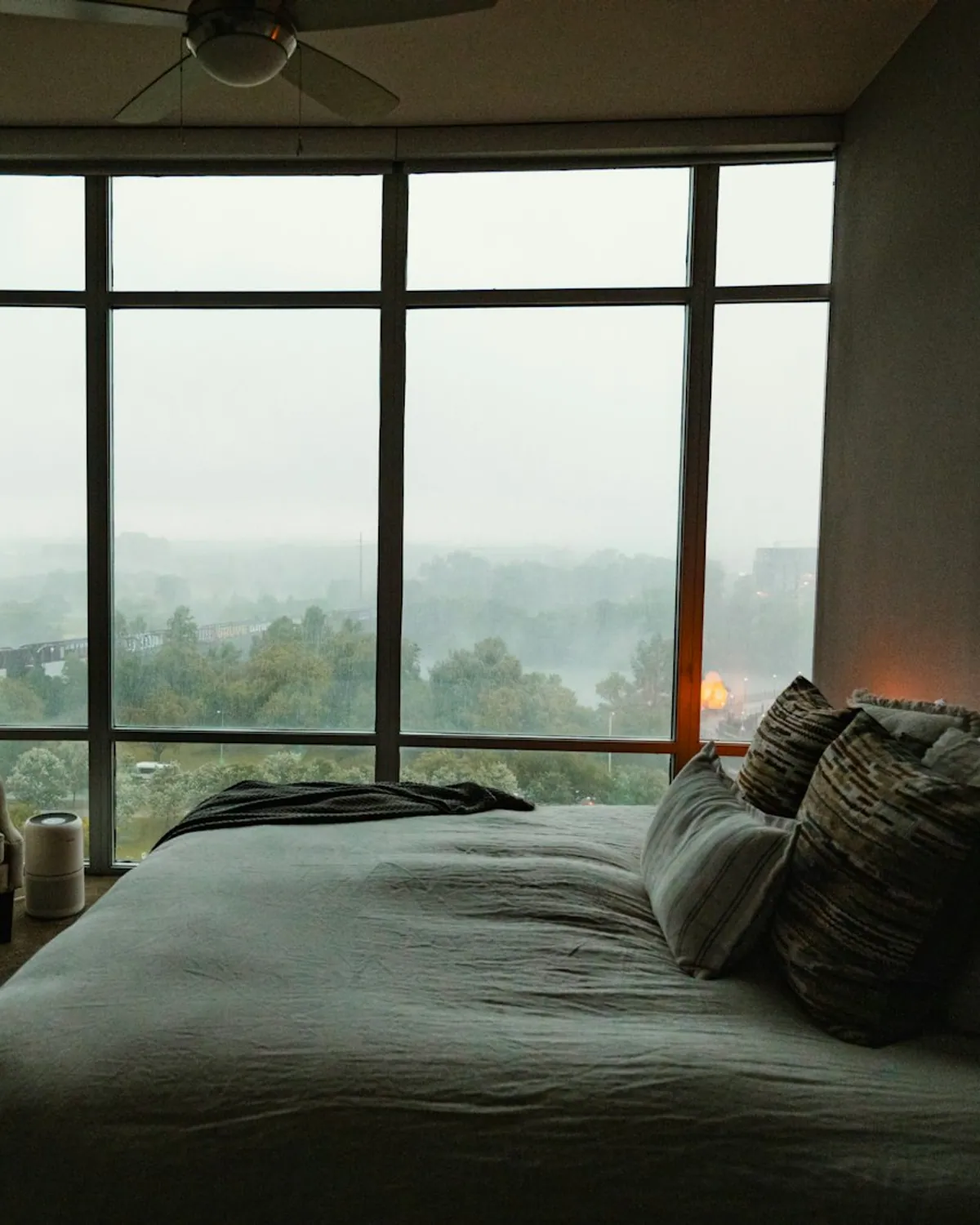 A bright, made bed with crisp white linens in a hospitality interior.