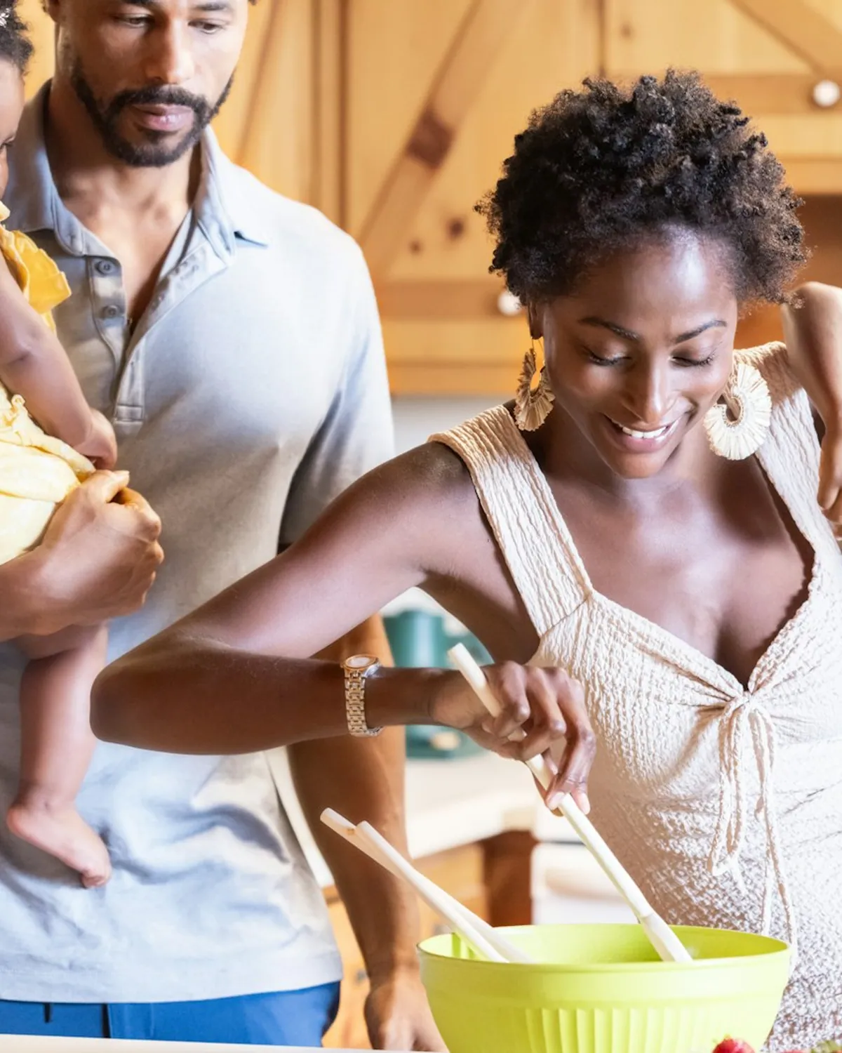 A family in a bright kitchen — the kind of moment a laundry gift card protects.